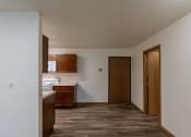 Thumbnail 14 of 19 - Grand Forks, ND Grandview Apartments, A dining room with a kitchen to the left, entry door, and a closet to the right.