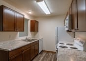 Thumbnail 12 of 19 - Grand Forks, ND Grandview Apartments. A kitchen with white appliances.