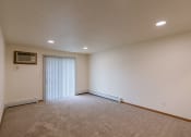 Thumbnail 9 of 19 - Grand Forks, ND Grandview Apartments. A living room with a glass sliding door.