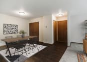 Thumbnail 4 of 28 - A dining room with a table and four chairs and the entry door in the background  at Harrison and Richfield, Grand Forks, North Dakota