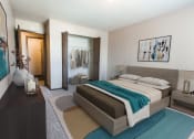 Thumbnail 4 of 20 - Grand Forks, ND Library Lane Apartments. a bedroom with a bed, dresser, and a closet