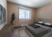 Thumbnail 5 of 20 - Grand Forks, ND Library Lane Apartments. a bedroom with a bed and a window
