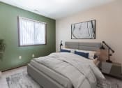 Thumbnail 5 of 7 - Grand Forks, ND Louise Apartments. A bedroom with a bed and a window