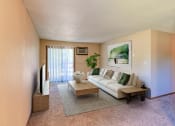 Thumbnail 2 of 12 - a living room with a white couch and a coffee table.  Grand Forks, ND Madison Apartments