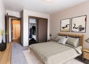 Thumbnail 5 of 16 - Grand Forks, ND Mayfair Apartments. a bedroom with a bed and a dresser in a room