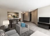 Thumbnail 3 of 25 - Grand Forks Primrose Apartments. A living room with a couch a chair and a tv