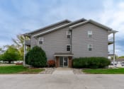 Thumbnail 25 of 25 - Grand Forks, ND Primrose Court Apartments. Exterior entrance to a three-level apartment building
