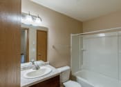 Thumbnail 26 of 28 - Grand Forks, ND Richfield Apartments. A bathroom with a sink, toilet, and bathtub
