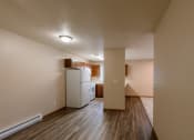 Thumbnail 23 of 28 - Grand Forks, ND Richfield Apartments. A dining room with a kitchen in the background.