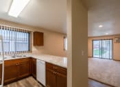 Thumbnail 22 of 28 - Grand Forks, ND Richfield Apartments. A view of the kitchen and living room from the counter top in an empty house