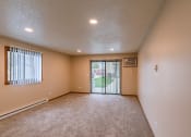 Thumbnail 20 of 28 - Grand Forks, ND Richfield Apartments. A living room with a sliding glass door to a patio