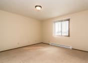 Thumbnail 8 of 10 - Grand Forks Ridgemont Apartments.  A bedroom with a window and baseboard heater.