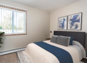 Thumbnail 5 of 23 - Grand Forks, ND Riverwood Apartments. A bedroom with a large bed and a window