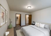 Thumbnail 6 of 22 - A bedroom with a large white bed and a green vase. Grand Forks, ND Southview Apartments.