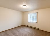 Thumbnail 10 of 22 - Grand Forks, ND Southview III Apartments. A living room with a window and carpeting