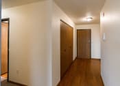 Thumbnail 9 of 22 - Grand Forks, ND Southview III Apartment. A hallway with a wooden door and a door to a closet