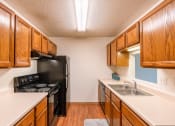 Thumbnail 20 of 22 - Grand Forks, ND Southview Apartments. A kitchen with black appliances.