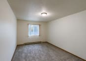 Thumbnail 16 of 22 - Grand Forks, ND Southview Apartments.  A bedroom with white walls and a window.