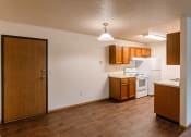 Thumbnail 14 of 22 - Grand Forks, ND Southview Apartments. A dining room with an entry door and the kitchen.