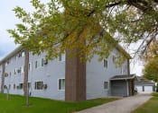 Thumbnail 22 of 22 - Grand Forks, ND Southview III Apartments. An apartment building with a sidewalk and a tree