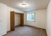 Thumbnail 12 of 22 - Grand Forks, ND Southview III Apartments. A room with a door to a closet and a window