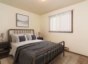 Thumbnail 4 of 10 - Grand Forks, ND Stanford Court Apartments  a bedroom with a bed and a window
