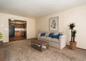 Thumbnail 1 of 10 - Grand Forks, ND Stanford Court Apartments  a living room with a couch and a coffee table