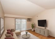 Thumbnail 1 of 19 - a living room with a couch and a tv on the wall  at Sterling Pointe, Grand Forks, ND