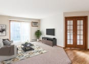 Thumbnail 3 of 19 - a living room with a white couch and a tv on the wall  at Sterling Pointe, Grand Forks, ND