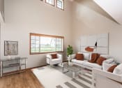 Thumbnail 4 of 19 - a living room with a white couch and a glass coffee table  at Sterling Pointe, Grand Forks