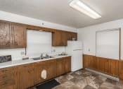 Thumbnail 4 of 6 - Grand Forks, ND Valley Home Duplex. a kitchen with white appliances and wooden cabinets