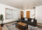 Thumbnail 2 of 6 - Grand Forks, ND Valley Home Duplex.  a living room with a black couch and a wooden coffee table