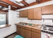 Thumbnail 4 of 8 - Grand Forks, ND Washington Apartments. A kitchen with a stove and a sink
