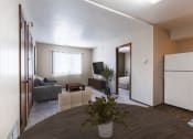 Thumbnail 3 of 7 - a living room with a dining room table and a kitchen