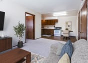 Thumbnail 2 of 7 - a living room with a couch and a view of a kitchen