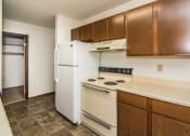 Thumbnail 6 of 19 - Grand Forks, ND Grandview I Apartments. a kitchen with white appliances and wooden cabinets