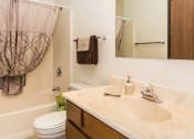 Thumbnail 8 of 19 - Grand Forks, ND Grandview I Apartments. A bathroom with a bathtub, sink, and toilet