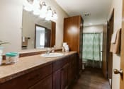 Thumbnail 11 of 17 - Grand Forks, ND Grandview II Apartments. A bathroom with a sink, toilet, and bathtub.