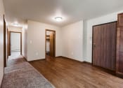 Thumbnail 7 of 17 - Grand Forks, ND Grandview II Apartments. A dining room with a hallway to the bedrooms and the main entry door with a laundry closet next to it.