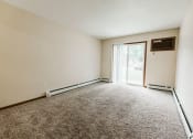 Thumbnail 1 of 17 - Grand Forks, ND Grandview II Apartments. A living room with a glass sliding door