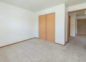 Thumbnail 6 of 21 - a bedroom with a closet and carpeted floors. Fargo, ND Sunrise North