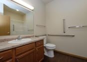 Thumbnail 17 of 23 - a bathroom with sink toilet and mirror. Fargo, ND North Sky Apartments