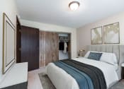 Thumbnail 3 of 7 - a bedroom with a bed and a closet. Bismarck, ND Hannifin Apartments