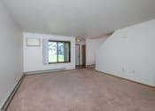 Thumbnail 6 of 14 - the living room and dining room of an apartment with carpeting and a window. Fargo, ND Hazelwood Townhomes