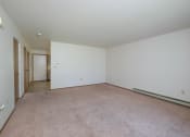 Thumbnail 7 of 14 - an empty living room with carpet and white walls. Fargo, ND Hazelwood Townhomes