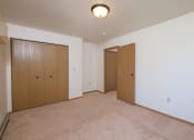 Thumbnail 9 of 14 - a bedroom with two doors and a closet. Fargo, ND Hazelwood Townhomes