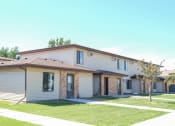 Thumbnail 13 of 14 - a white house with a yard and a sidewalk. Fargo, ND Hazelwood Townhomes