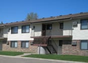 Thumbnail 10 of 10 - an apartment building with stairs on the side of it. Bismarck, ND Highland Meadows Apartments