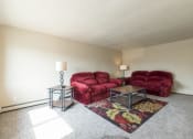 Thumbnail 4 of 10 - a living room with two couches and a rug. Bismarck, ND Highland Meadows Apartments