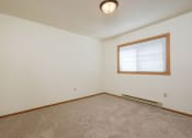 Thumbnail 7 of 9 - a bedroom with a window.  Fargo, ND Hunters Run Apartments